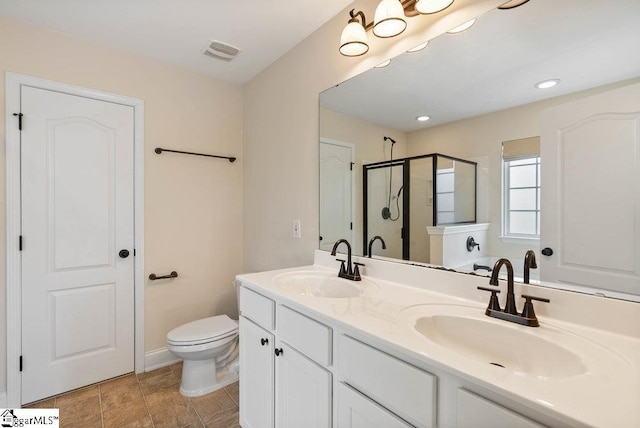 bathroom with a sink, a stall shower, double vanity, and visible vents