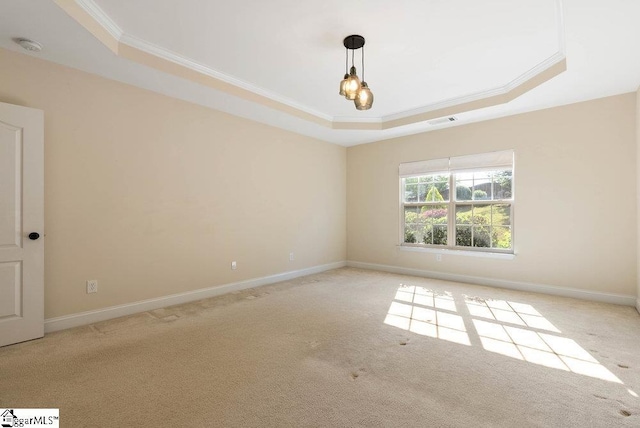 carpeted empty room featuring crown molding, baseboards, visible vents, and a raised ceiling