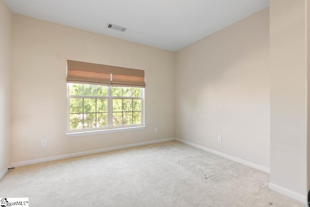 empty room with visible vents, carpet flooring, and baseboards