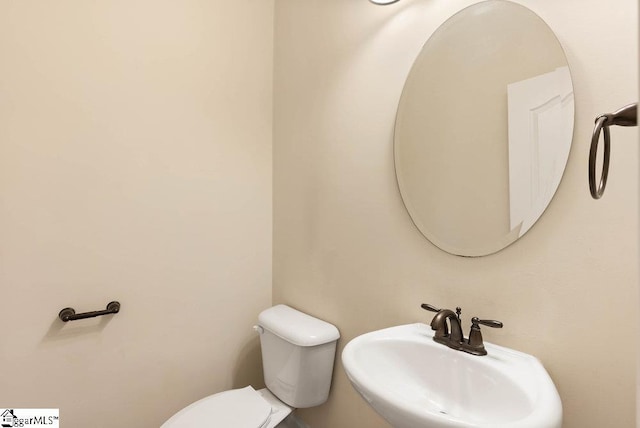 bathroom with toilet and a sink