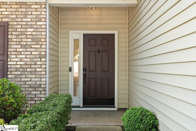 property entrance with brick siding