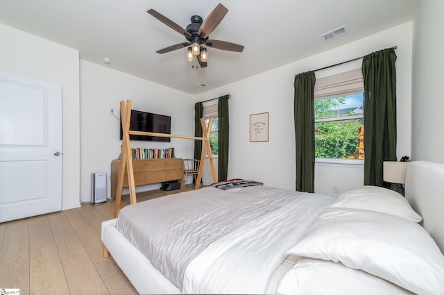 bedroom featuring visible vents, ceiling fan, and light wood-type flooring