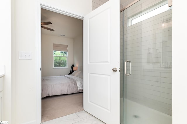 ensuite bathroom featuring visible vents, a ceiling fan, a shower stall, and connected bathroom
