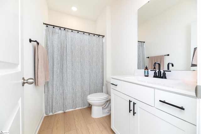 full bath featuring vanity, curtained shower, toilet, and wood finished floors