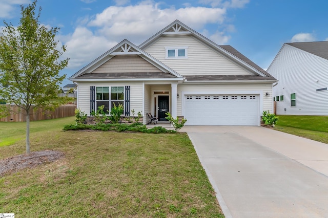 craftsman house featuring fence, an attached garage, concrete driveway, and a front yard