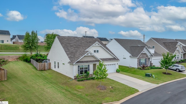 view of front facade featuring a residential view, a shingled roof, a garage, a front yard, and driveway