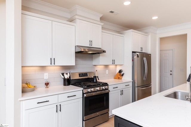 kitchen featuring under cabinet range hood, stainless steel appliances, visible vents, and light countertops