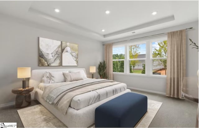 carpeted bedroom featuring recessed lighting, baseboards, and a raised ceiling