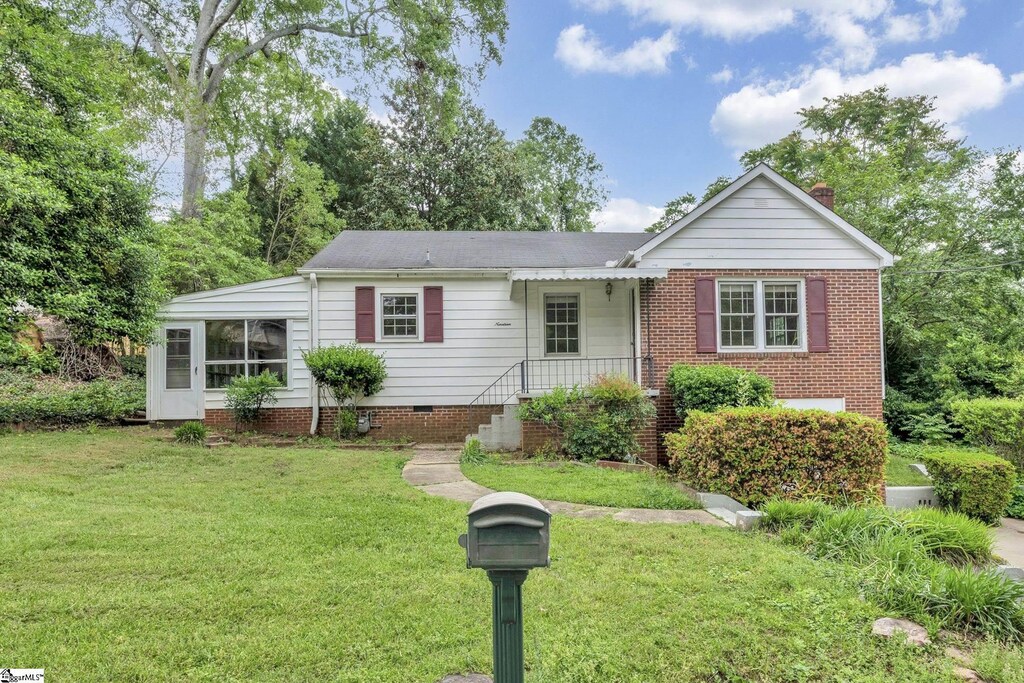 single story home featuring a chimney and a front yard