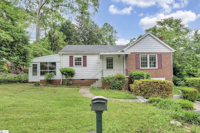 single story home featuring a chimney and a front yard