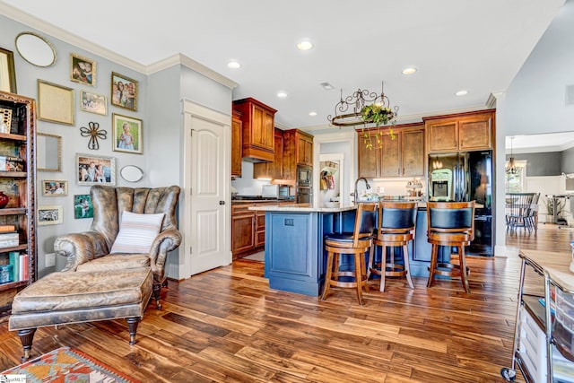 kitchen with dark wood-style flooring, ornamental molding, and built in microwave
