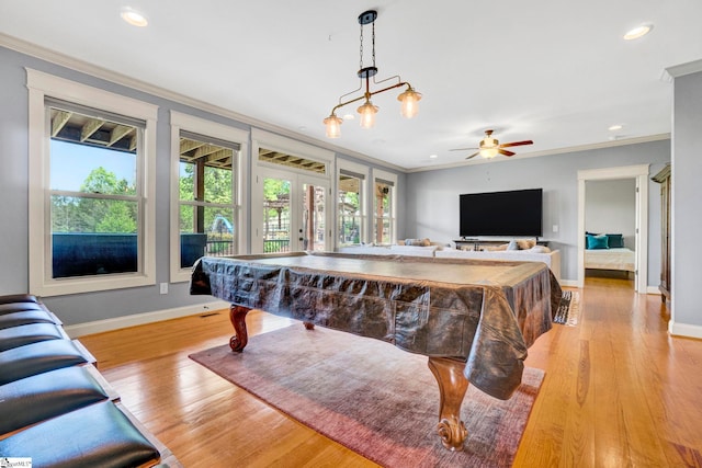 game room featuring crown molding, baseboards, and light wood-style floors