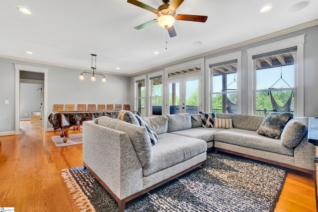 living room featuring crown molding, recessed lighting, and a wealth of natural light