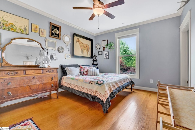 bedroom with crown molding, baseboards, ceiling fan, and light wood-type flooring