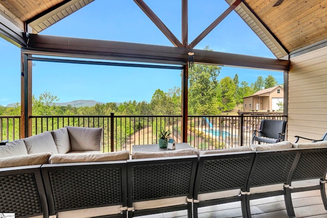 deck featuring outdoor lounge area and a mountain view