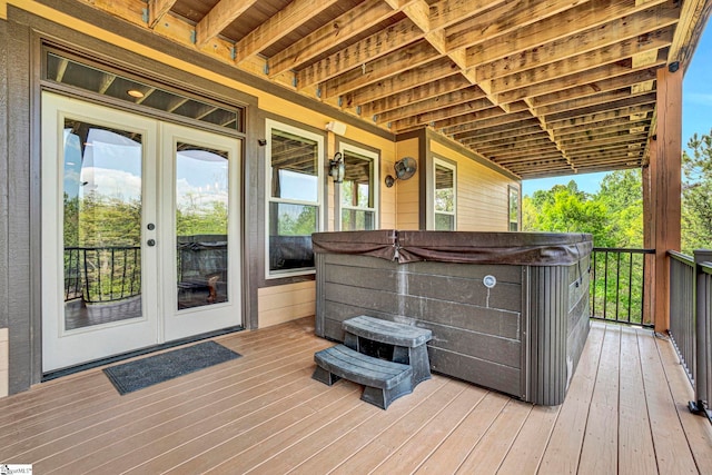 wooden terrace with french doors and a hot tub