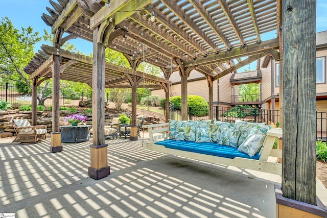 view of patio / terrace featuring a pergola and fence