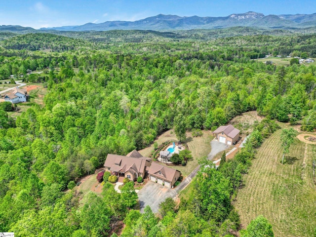 drone / aerial view with a mountain view and a forest view