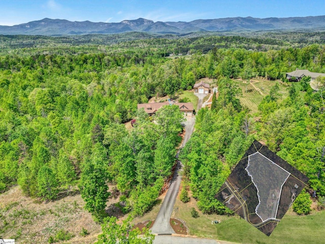drone / aerial view with a forest view and a mountain view