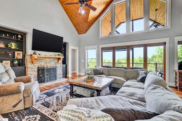 living room featuring wood finished floors, baseboards, high vaulted ceiling, wooden ceiling, and a ceiling fan