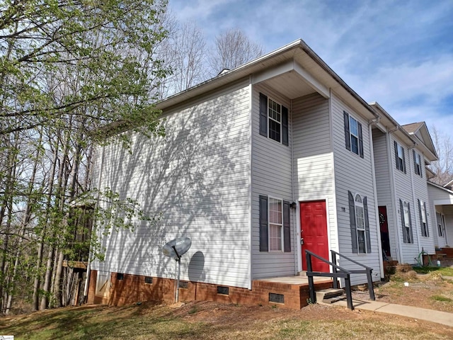 view of side of home featuring crawl space