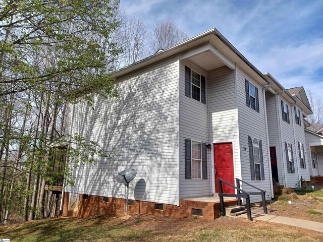 view of side of home featuring crawl space