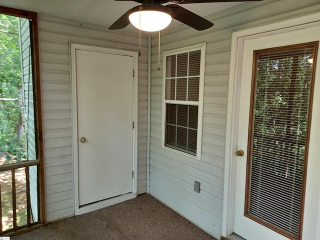 property entrance featuring a ceiling fan
