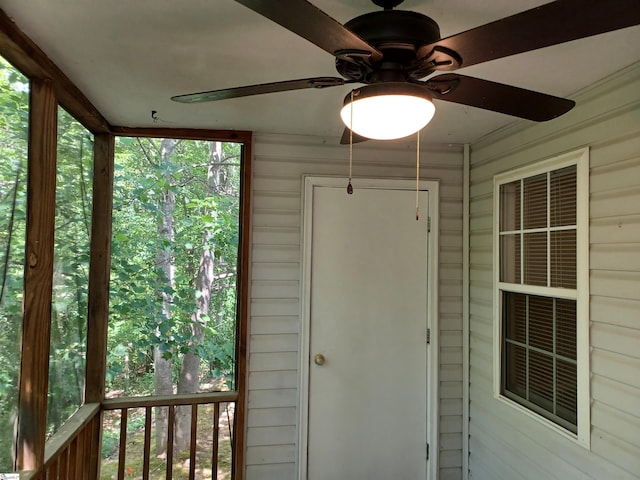 unfurnished sunroom with a ceiling fan