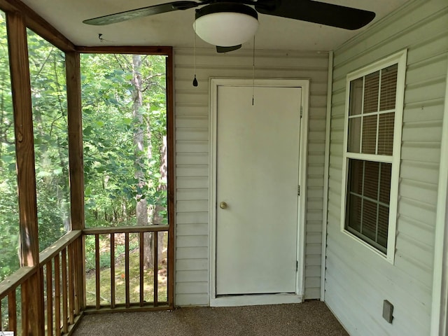 view of exterior entry with ceiling fan