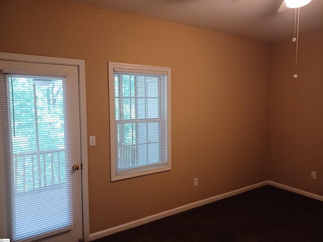 doorway to outside with a ceiling fan and baseboards