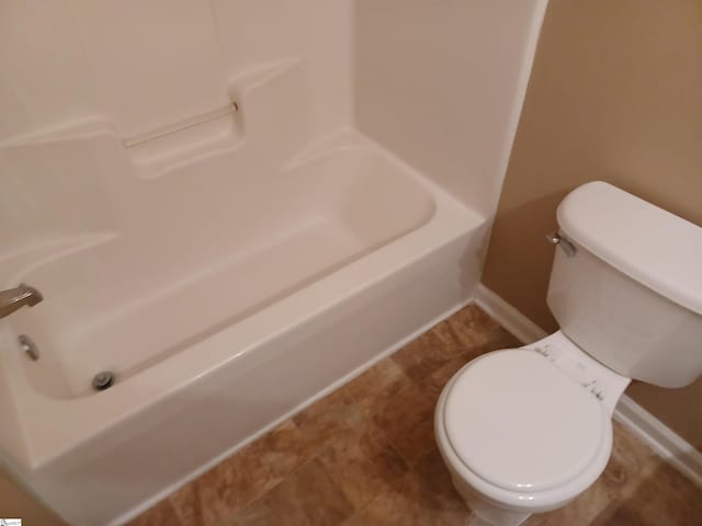 bathroom featuring toilet and baseboards