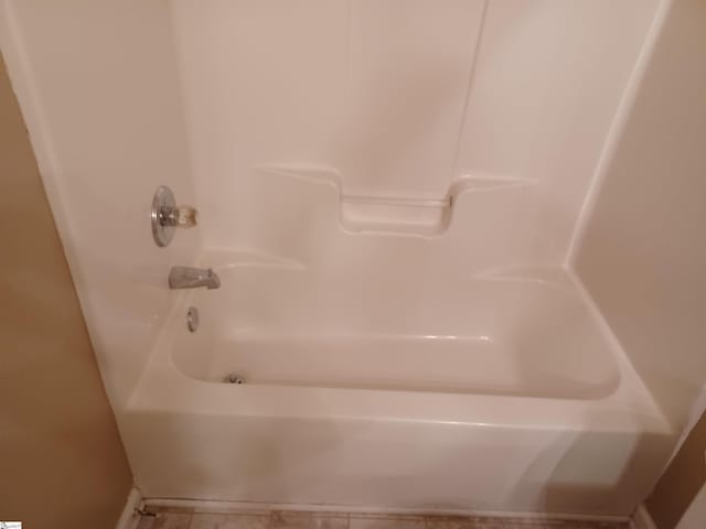 full bath featuring bathing tub / shower combination and tile patterned flooring