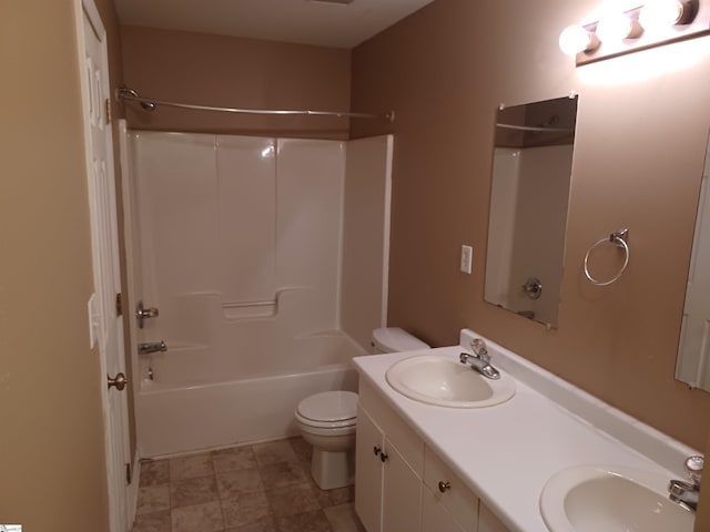 bathroom featuring toilet, bathtub / shower combination, and double vanity