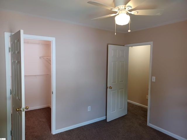 unfurnished bedroom with carpet floors, a closet, baseboards, and a ceiling fan