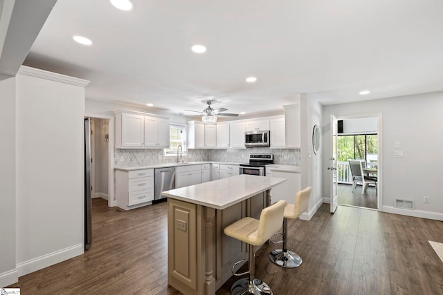 kitchen featuring appliances with stainless steel finishes, plenty of natural light, decorative backsplash, and visible vents