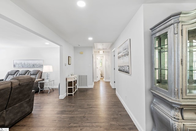 corridor with recessed lighting, visible vents, dark wood-style floors, and attic access