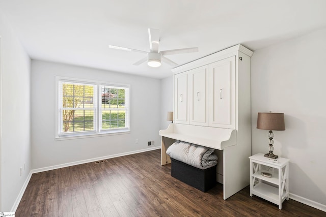 office with baseboards, a ceiling fan, dark wood-style flooring, and visible vents