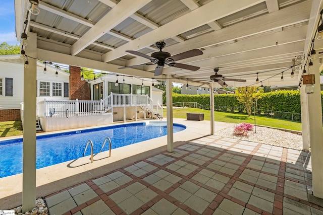 outdoor pool featuring a patio, a fenced backyard, ceiling fan, and a deck