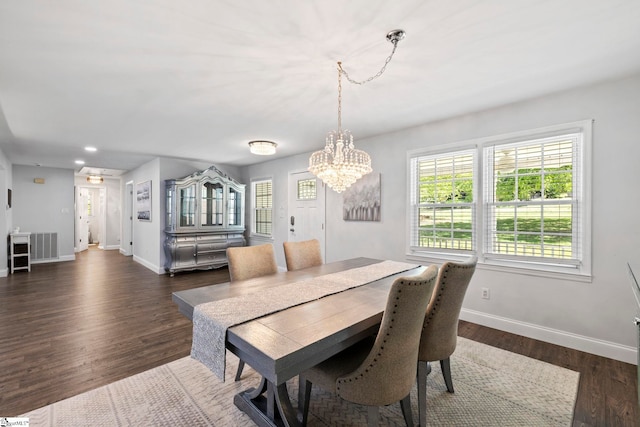 dining room featuring a notable chandelier, dark wood finished floors, recessed lighting, baseboards, and visible vents
