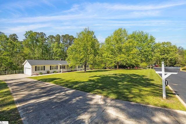 exterior space with an attached garage, a yard, and driveway