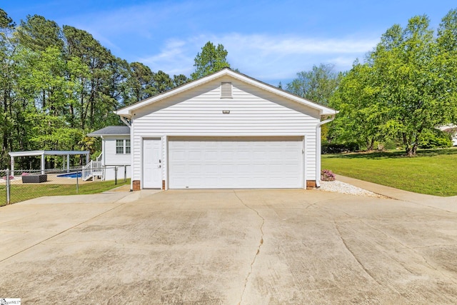 garage with concrete driveway and fence