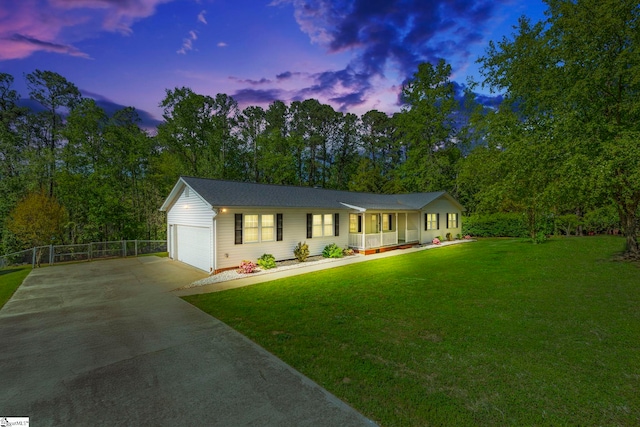 view of front of home featuring covered porch, fence, concrete driveway, and a front lawn