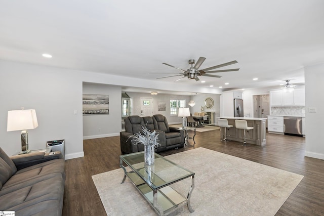 living area with recessed lighting, ceiling fan, and baseboards