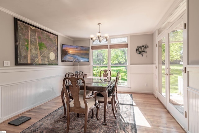 104 Bellewood Dr, Easley, SC 29640 - dining room featuring light wood-style floors, wainscoting, a decorative wall, and a chandelier