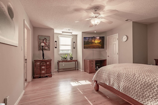 104 Bellewood Dr, Easley, SC 29640 - bedroom with visible vents, baseboards, ceiling fan, light wood-type flooring, and a textured ceiling
