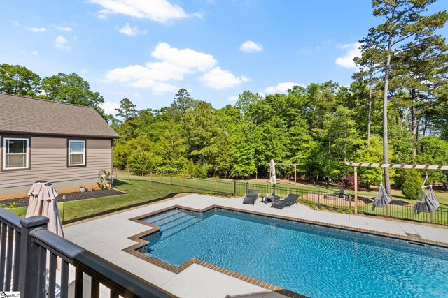 view of swimming pool with a yard, fence, a patio area, and a fenced in pool