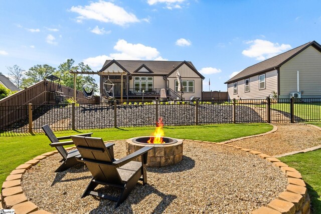 view of yard featuring a fire pit and fence