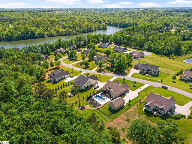 birds eye view of property with a water view, a residential view, and a wooded view