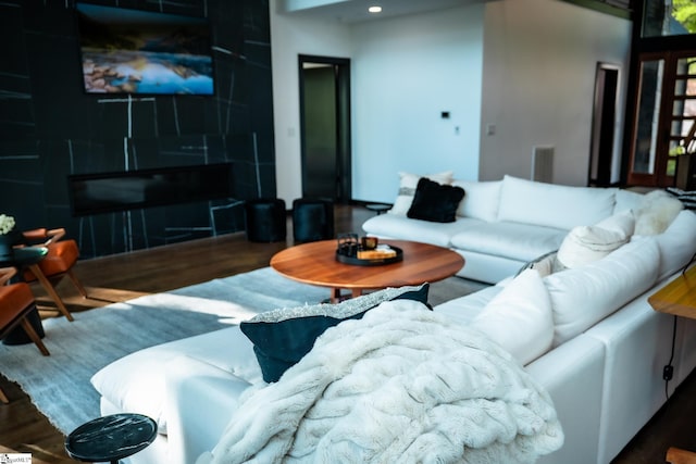 living room featuring recessed lighting, wood finished floors, and visible vents