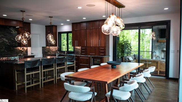 dining room featuring recessed lighting, plenty of natural light, and dark wood-style floors